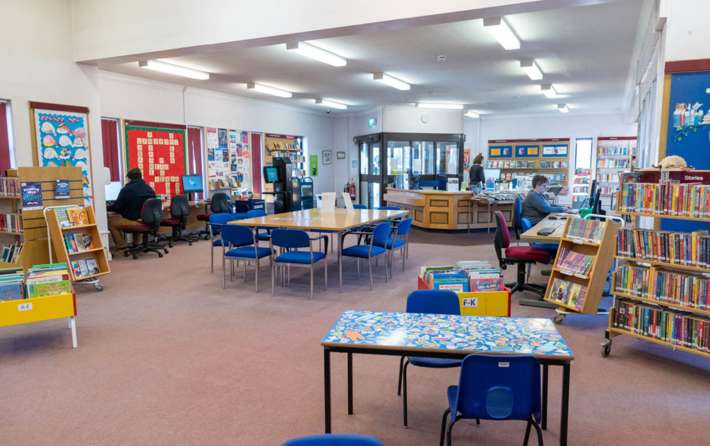 Main library area at Langport Library with study tables, public computers, children's book displays and open space for reading, learning and community activities.