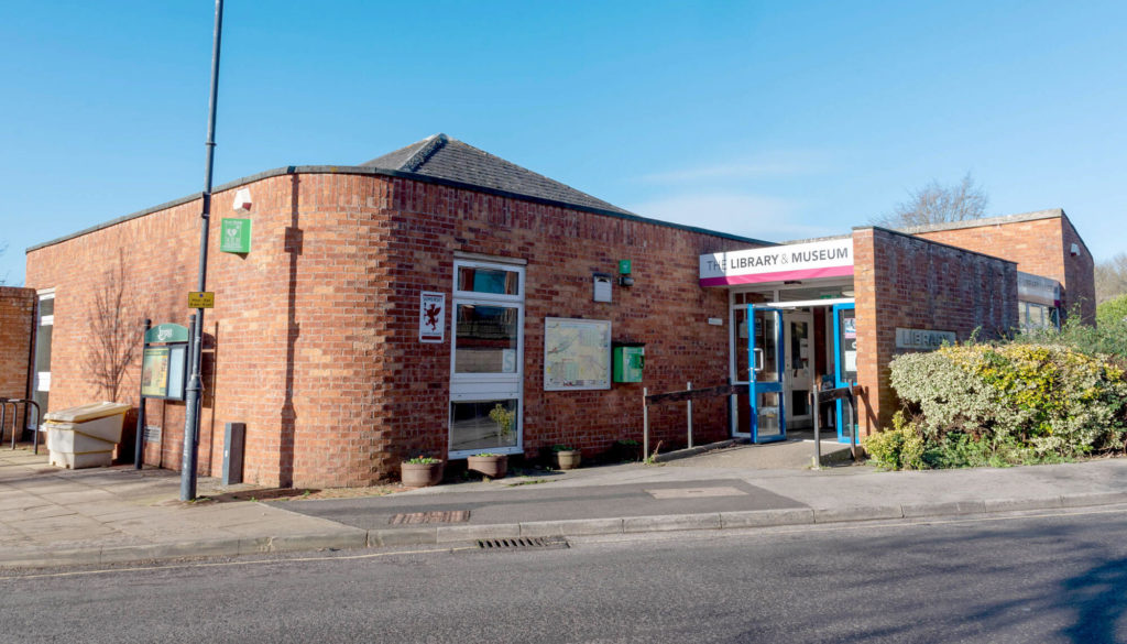 Exterior of Wincanton Library and Museum, a red-brick community building with accessible entrance, library and museum signage, and pedestrian access from the street.