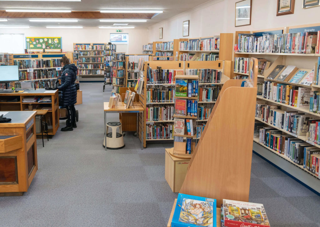 Main library area at Somerton Library with biography, travel and fiction collections, display shelving, customer service desk and open space for browsing and borrowing.
