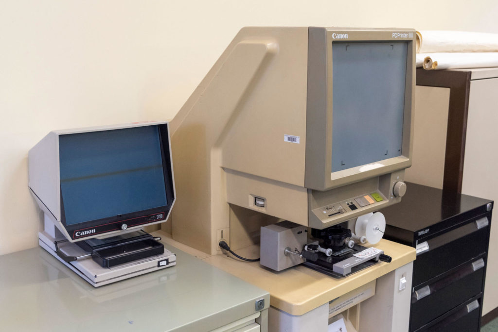 Microfilm reader and archive viewing equipment at Wells Library, providing access to historical newspapers, records and local history resources.