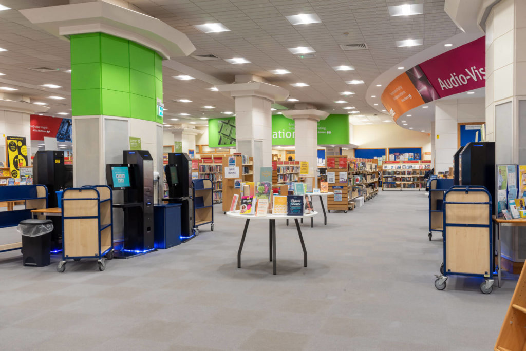 Digital technology area at Taunton Library with public computer workstations, a 3D printer, technology displays and information about the library's creative digital services.
