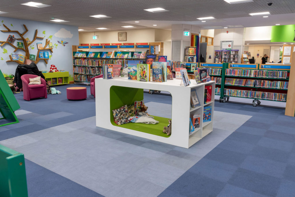 Children's library area at Taunton Library with low-level book displays, themed shelving, reading nooks, comfortable seating and open space for families and young readers.