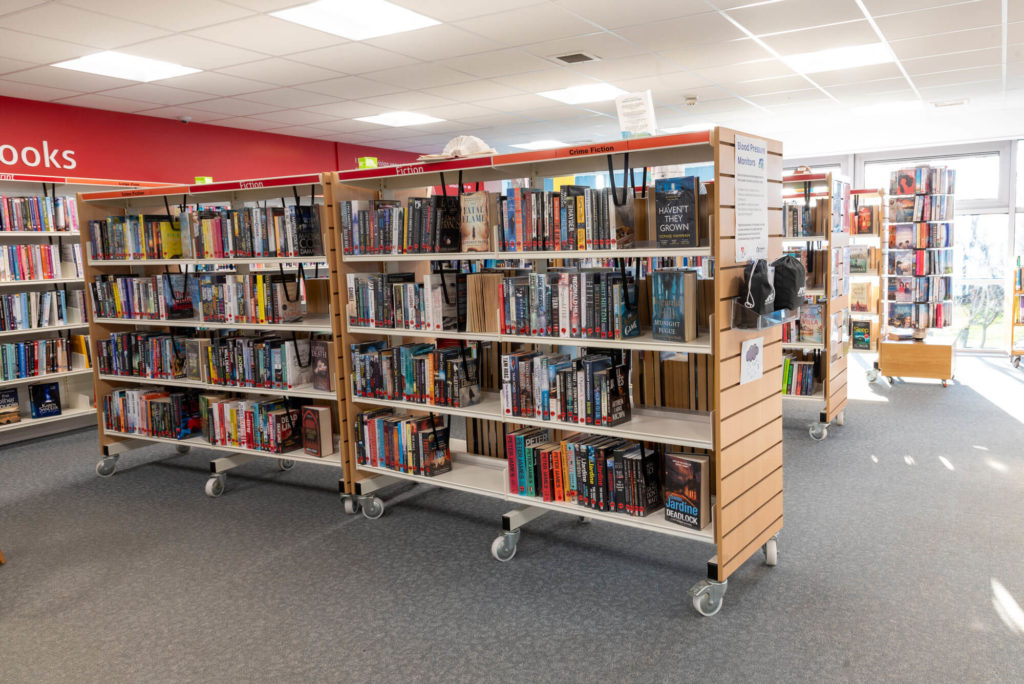 Crime fiction and fiction collections at Priorswood Library with mobile book shelves, clearly labelled sections and wide aisles for browsing and borrowing.