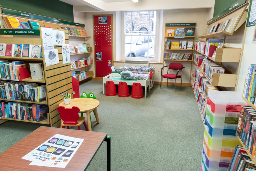 Children's area at Dulverton Library with picture books, low-level book storage, activity table and seating for young readers and families.