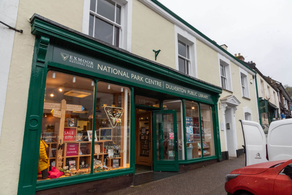 Exterior of Dulverton Library and Exmoor National Park Centre, showing the shared entrance, large display windows and signage on the high street.
