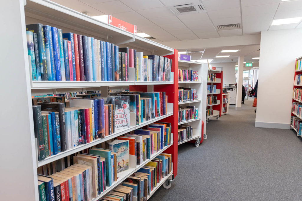 Fiction section at Wellington Library with rows of clearly labelled bookshelves, extensive adult fiction collections and wide aisles for browsing and borrowing.