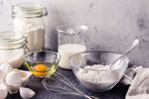 Image of flour, milk, egg and sugar in bowls