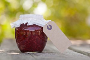 A sealed jar of jam with an empty tag 