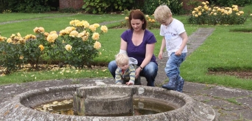 Family around the fountain at Blake Gardens