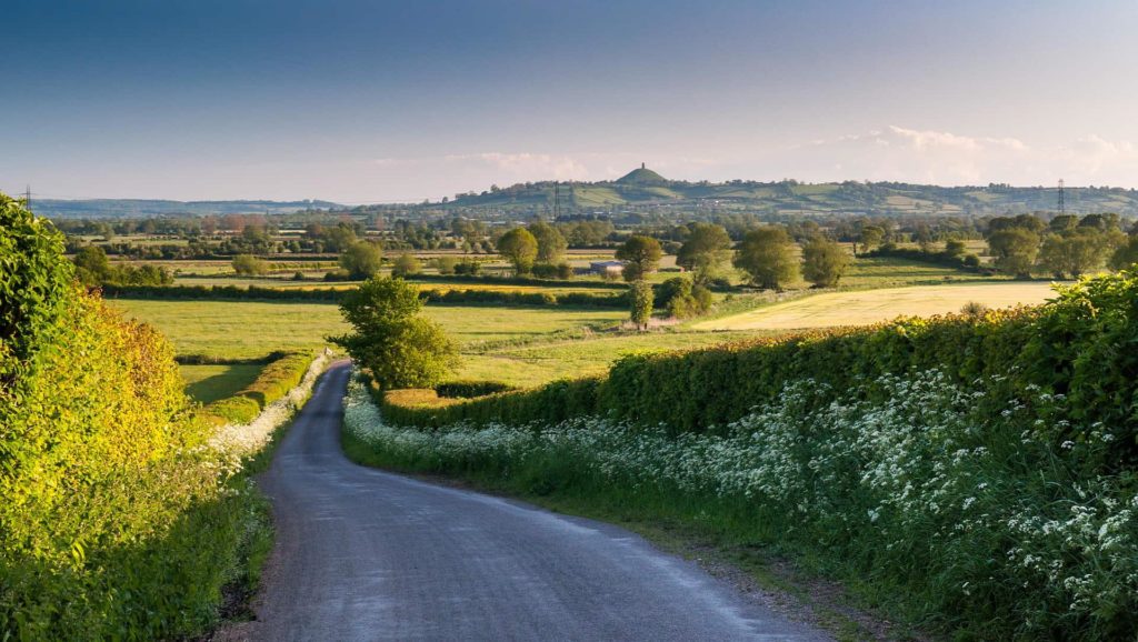 photograph of a country road looking towards Glastonbury tor