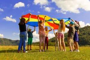 Children playing with parachute photograph