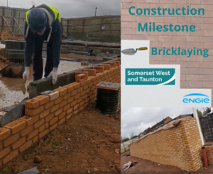 A construction worker laying bricks