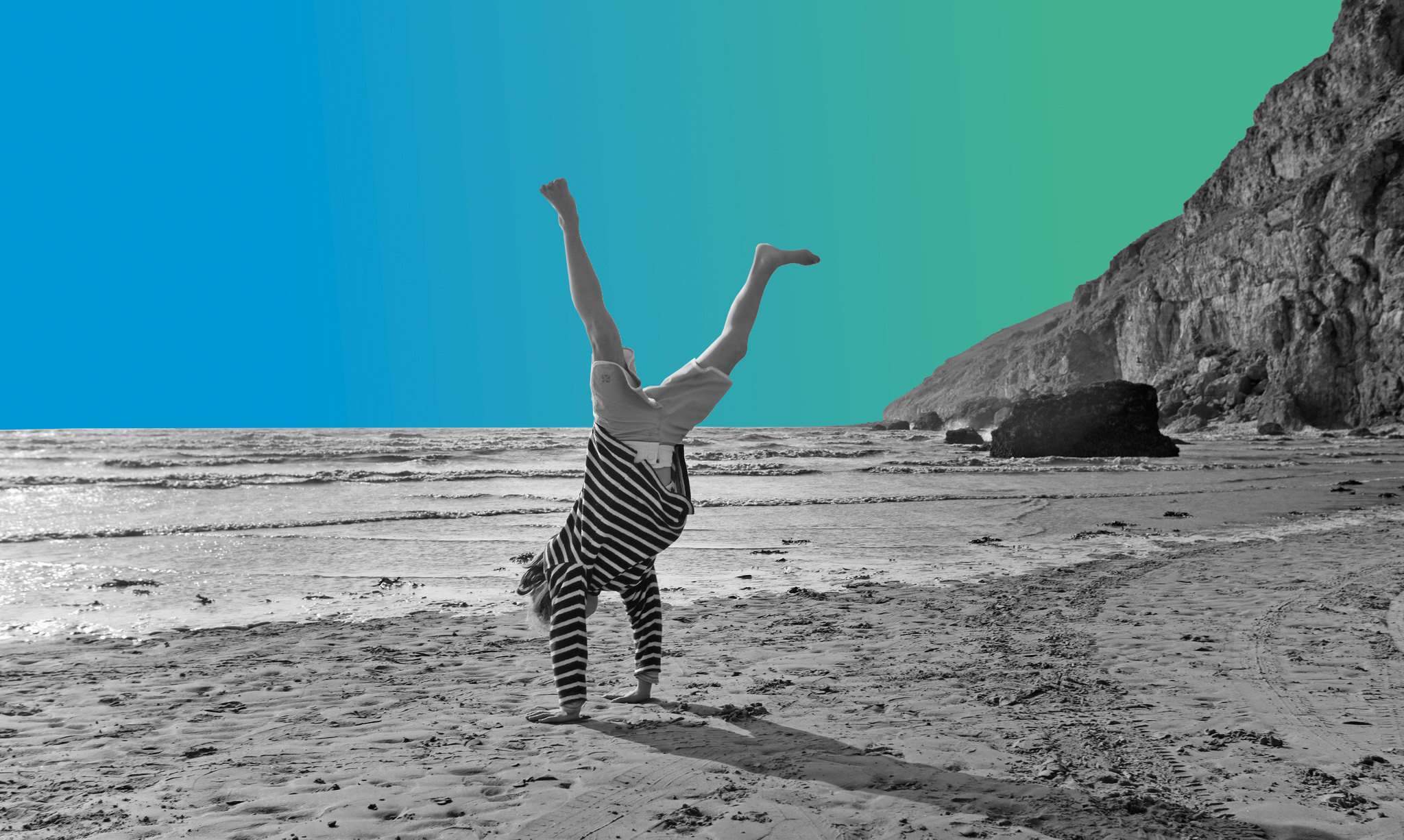 Woman doing a handstand on a beach