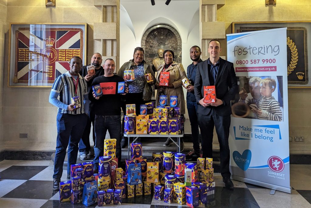 From L to R: Brilliant Phiri, Dean Hewins, Jamie Corrado, Cecilia Zinzombe, Rosemary Magwenzi, Farai Chikomo, Adam Knight , posing with the donated Easter eggs