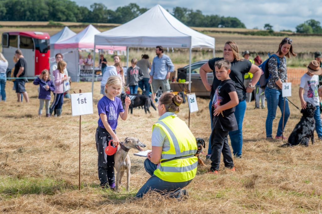 Ham Hill Dog Show-A child and her dog receiving their prize at a previous Ham Hill dog show