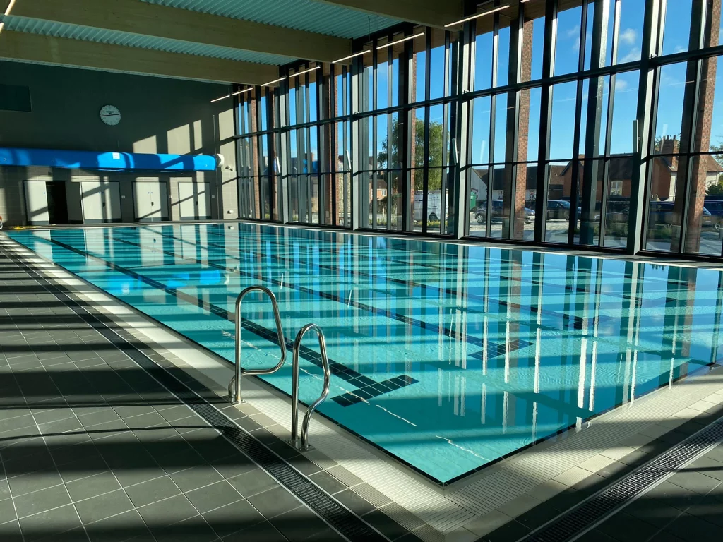 The Chard Leisure Centre main pool. It is inside a large room with floor to ceiling windows. The pool appears to have five lanes.