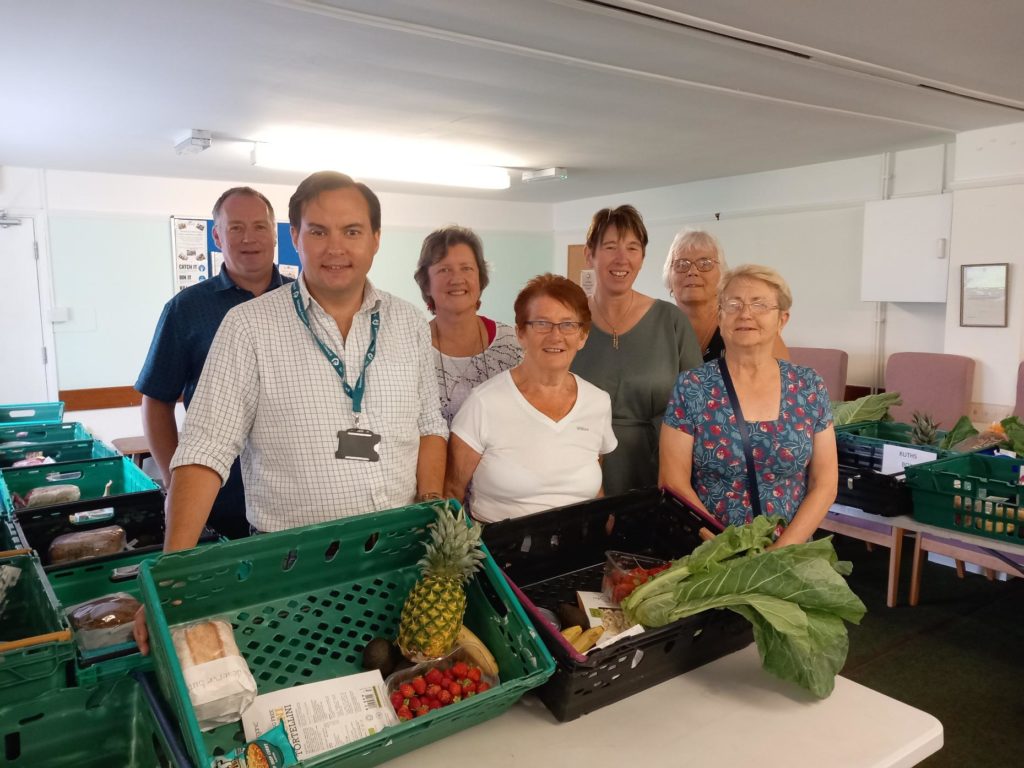 Cllr Theo Butt Philips with some of the Highbridge and Burnham on Sea Local Pantry team – with some of the items being prepared for the hampers.