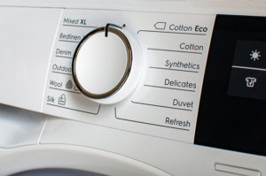 Close up of tumble dryer dial with drying settings