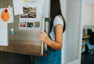 Someone holding a fridge door open