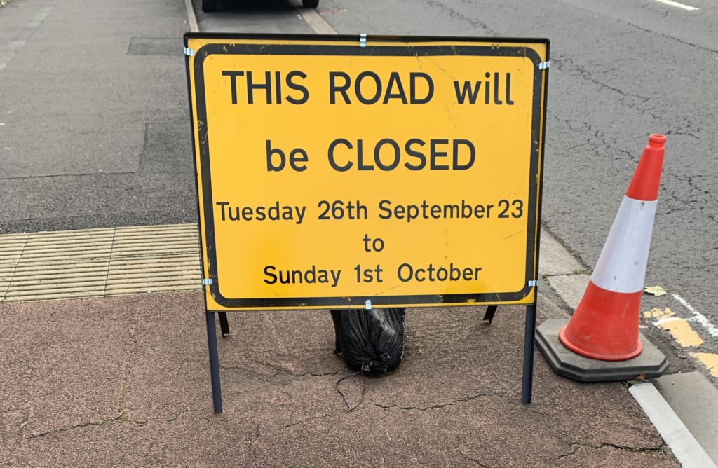 Image of yellow road sign saying, This Road will be closed from 9am on Tuesday 26 September until Sunday 1st October