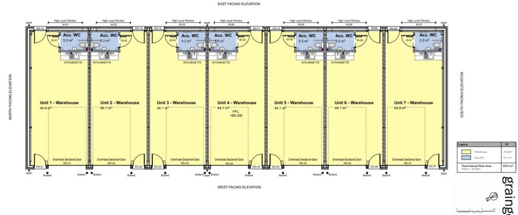 A floor plan of the units. Seven units each contain a kitchenette and bathroom, with an overhead sectional door on the west facing wall.