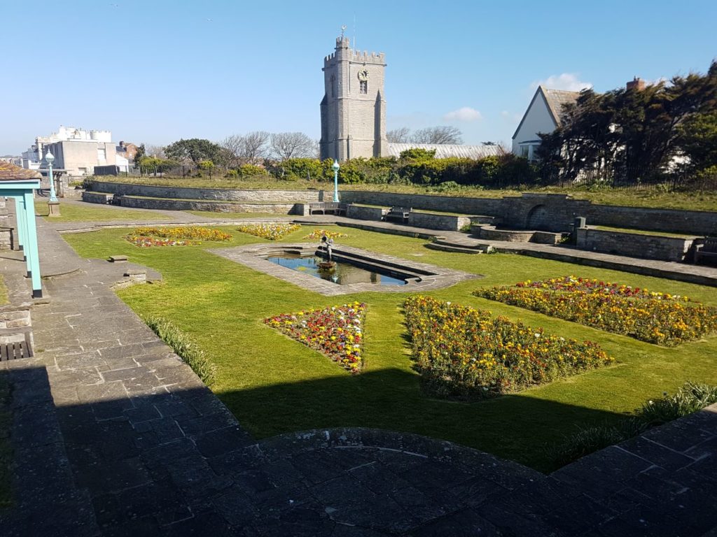 Marine Cove Gardens, view of art deco pond and St Andrew's church