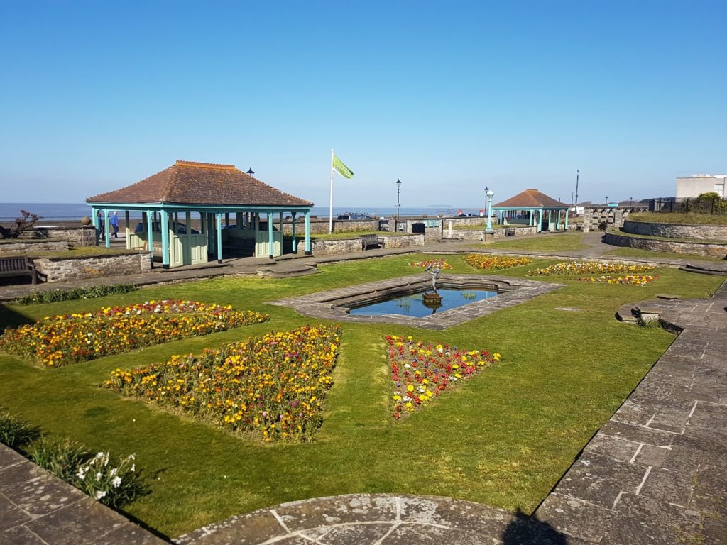 Marine Cove Gardens, view of the gardens with the sea in the background