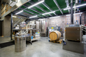 The inside of Barle Exmoor Distillery showing an industrial space with lots of equipment.