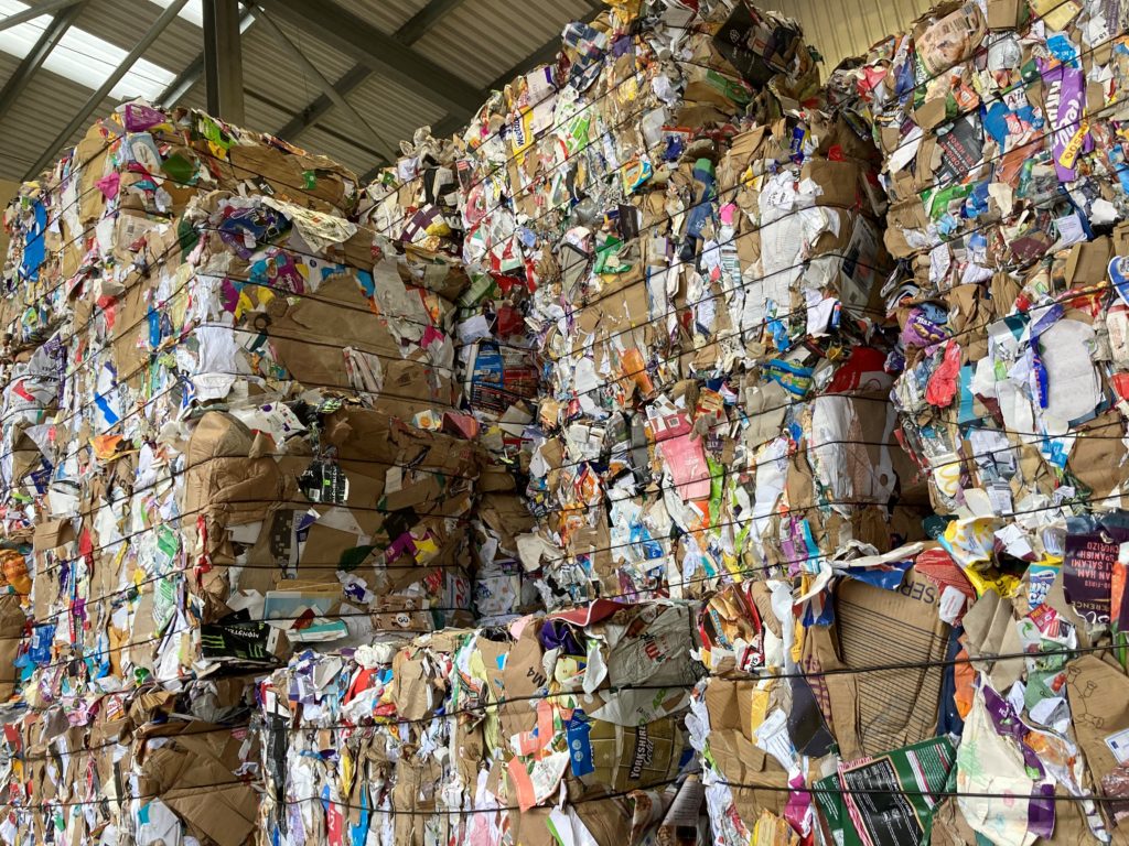 Bales of cardboard stacked high at the Material Recovery Facility