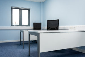 An office space with two desks opposite each other.