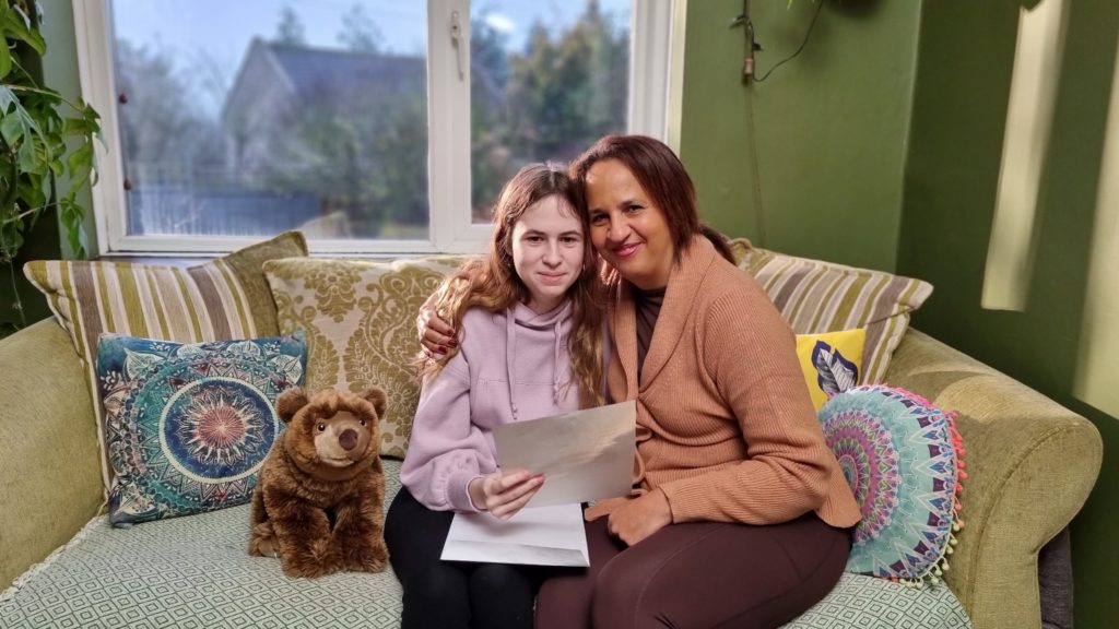 Fostering in Somerset advert - child and woman sat on sofa