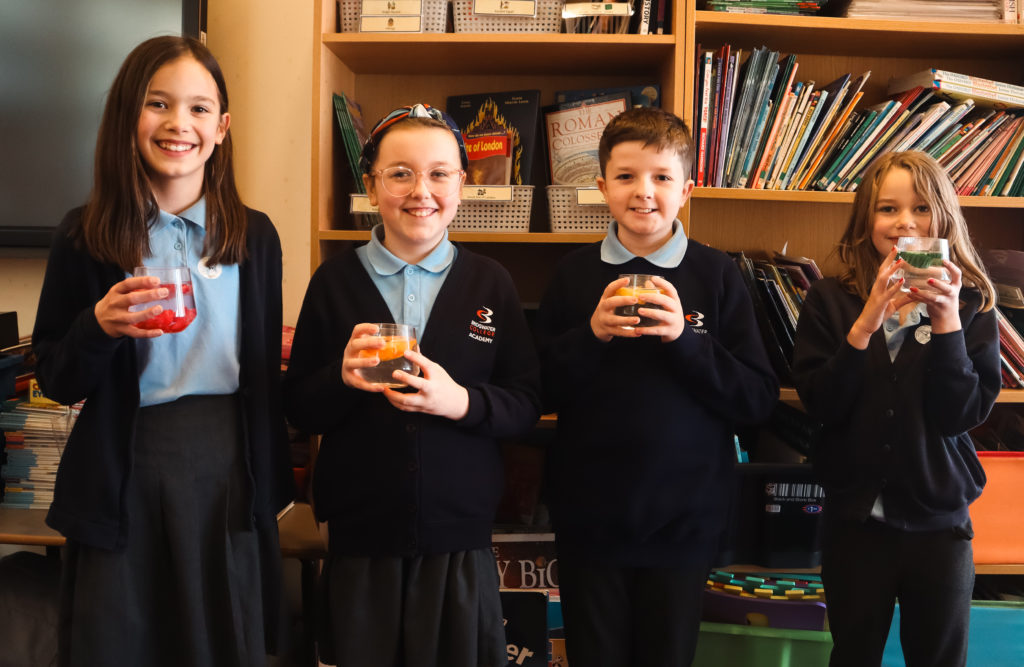 Pupils holding glasses of water