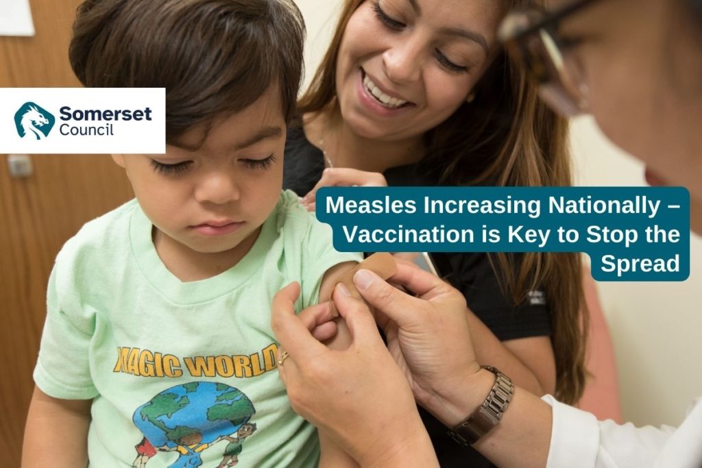 Photograph of a child getting a plaster for a measles vaccination jab