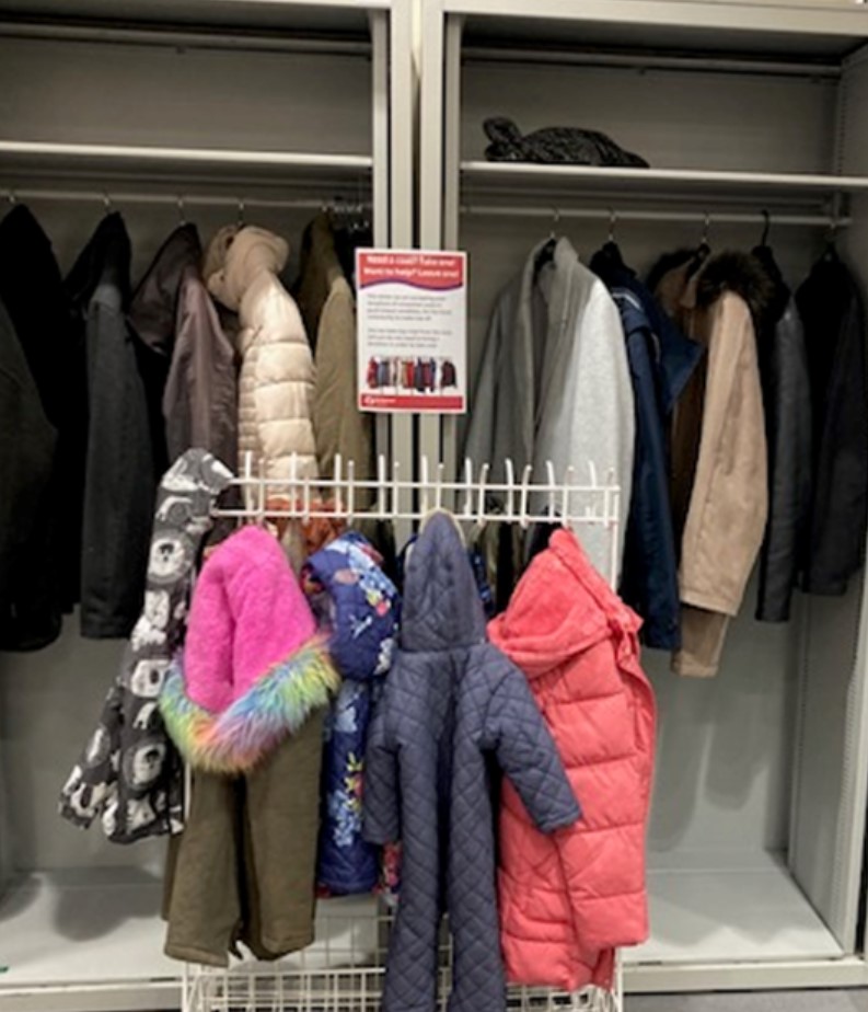 Rail of donated coats in a library
