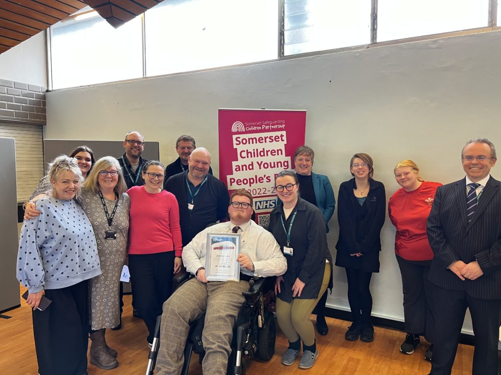 Josh poses for a photo at the celebration event