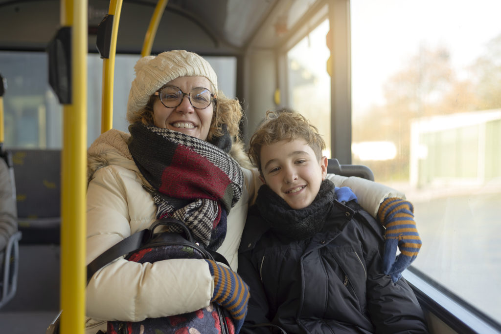 A woman and her child travelling on a public bus like the No 1 service
