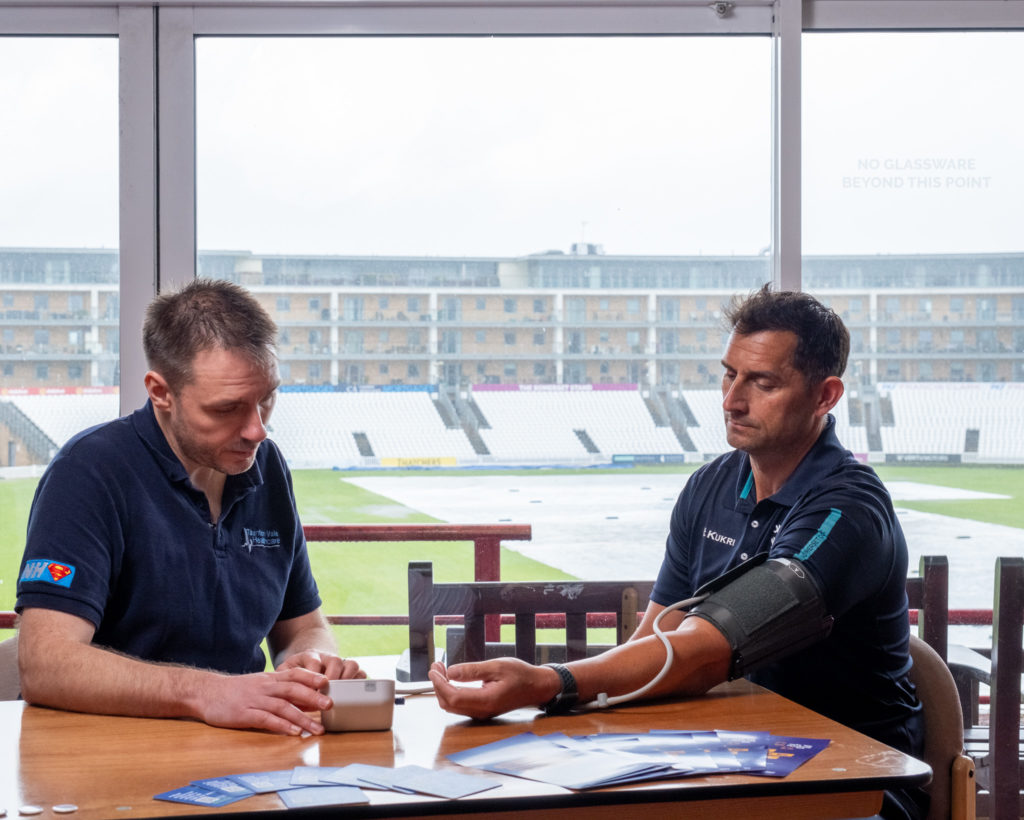 Somerset Cricket Head Coach, Jason Kerr, having his blood pressure taken by Dr Tim Norbury from Taunton Vale Healthcare.