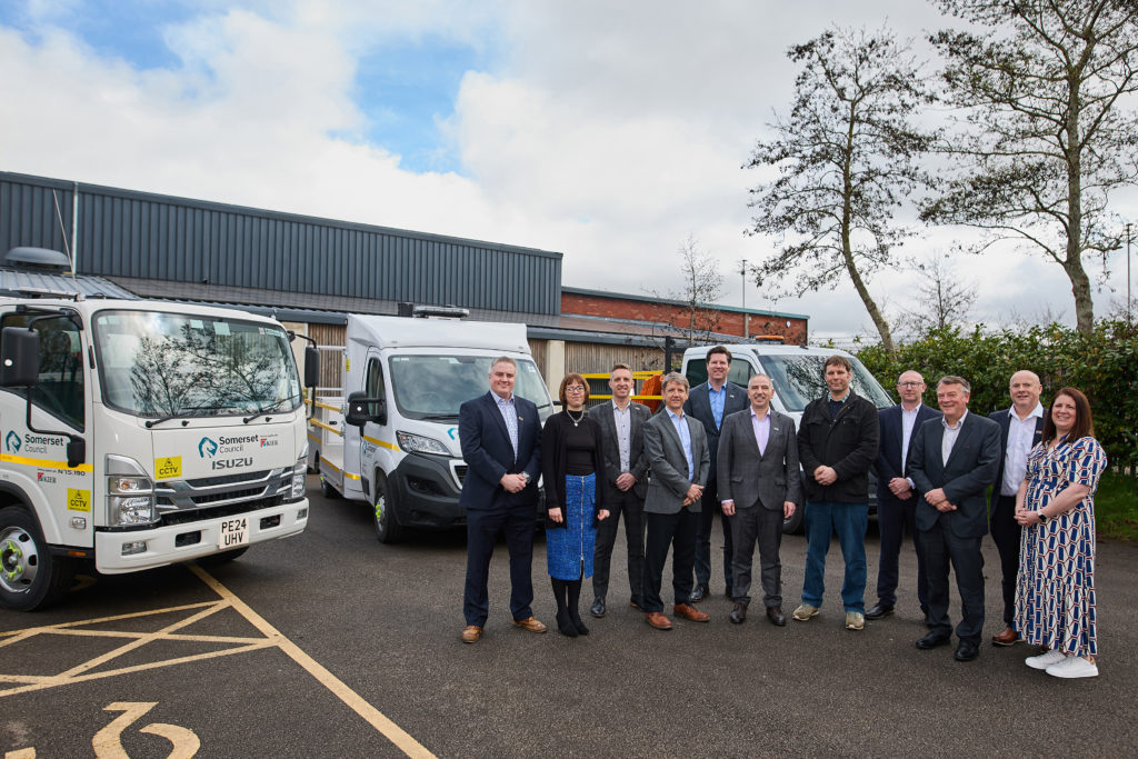 People from Somerset Council and Kier Transport at the Kier Somerset Transport launch. They are stood in front of highways maintenance vehicles with the Somerset Council branding on