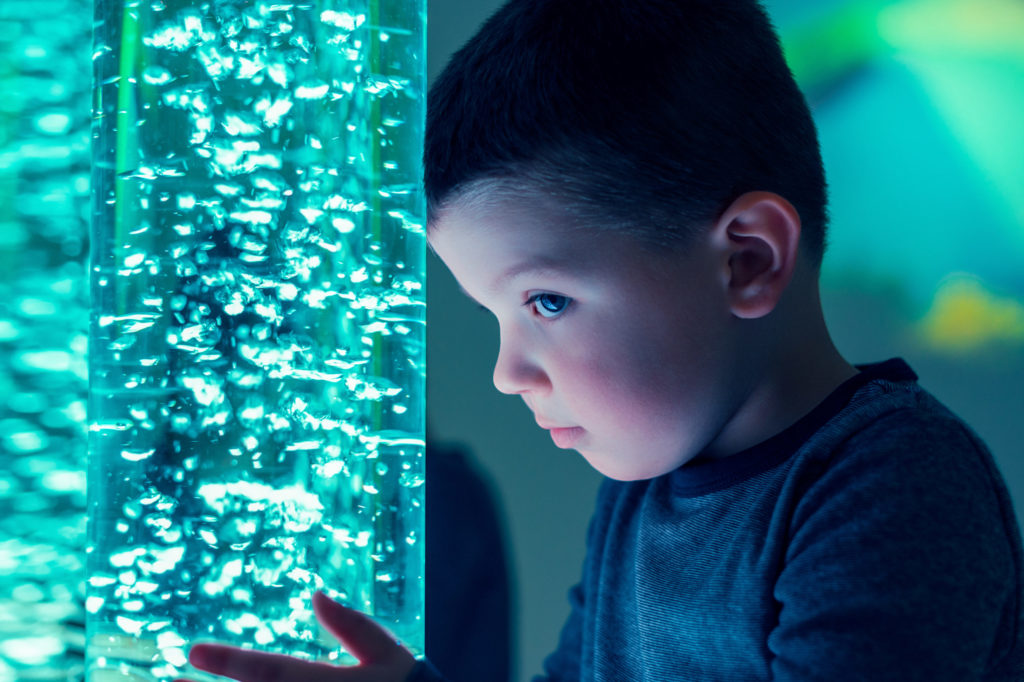 Child in therapy sensory stimulating room,