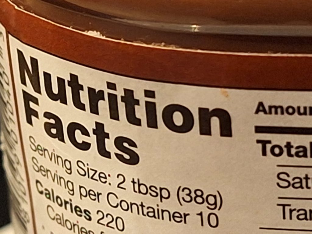 Close-up of a nutritional facts label on the side of a jar.