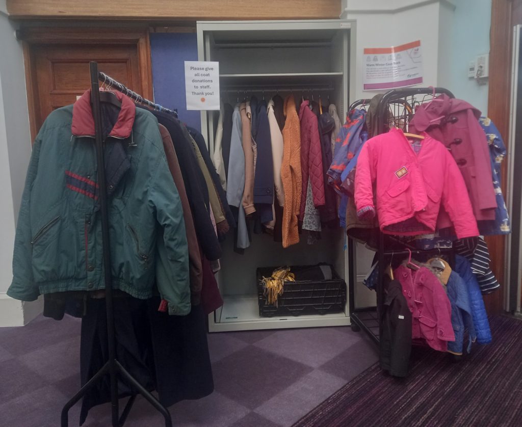 A selection of winter coats for adults and children on display in a Somerset library.