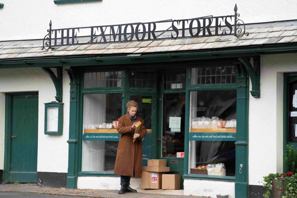 A still from the film Unmoored showing a woman outside The Exmoor Stores