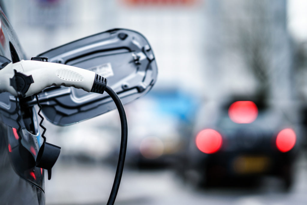Vehicle being plugged into electric charge point