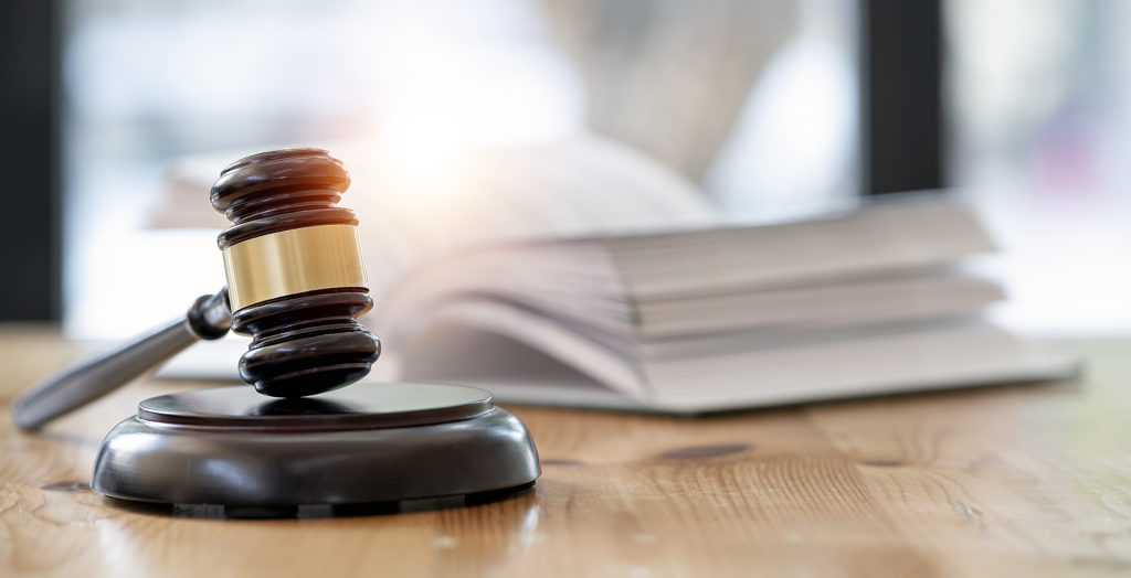 Wooden brown judge gavel on the table.