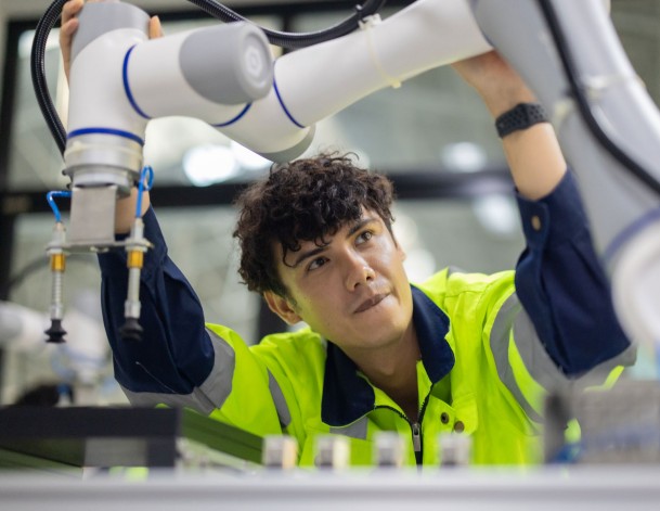 Young worker handling a technical instrument