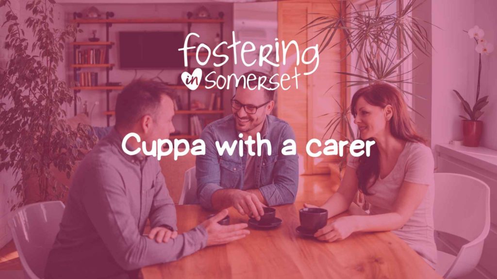 Three people sit at a wooden table with mugs, chatting under the text “Fostering in Somerset – Cuppa with a carer”.