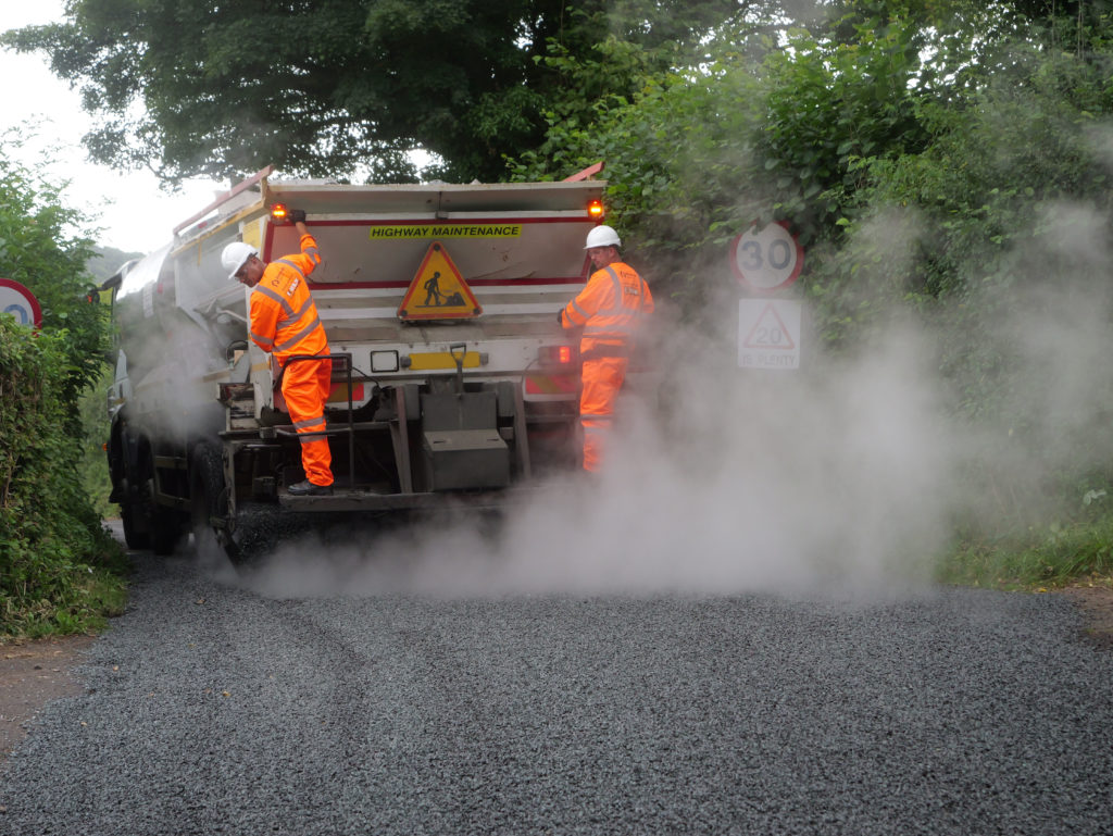 A team surface dressing a Somerset road