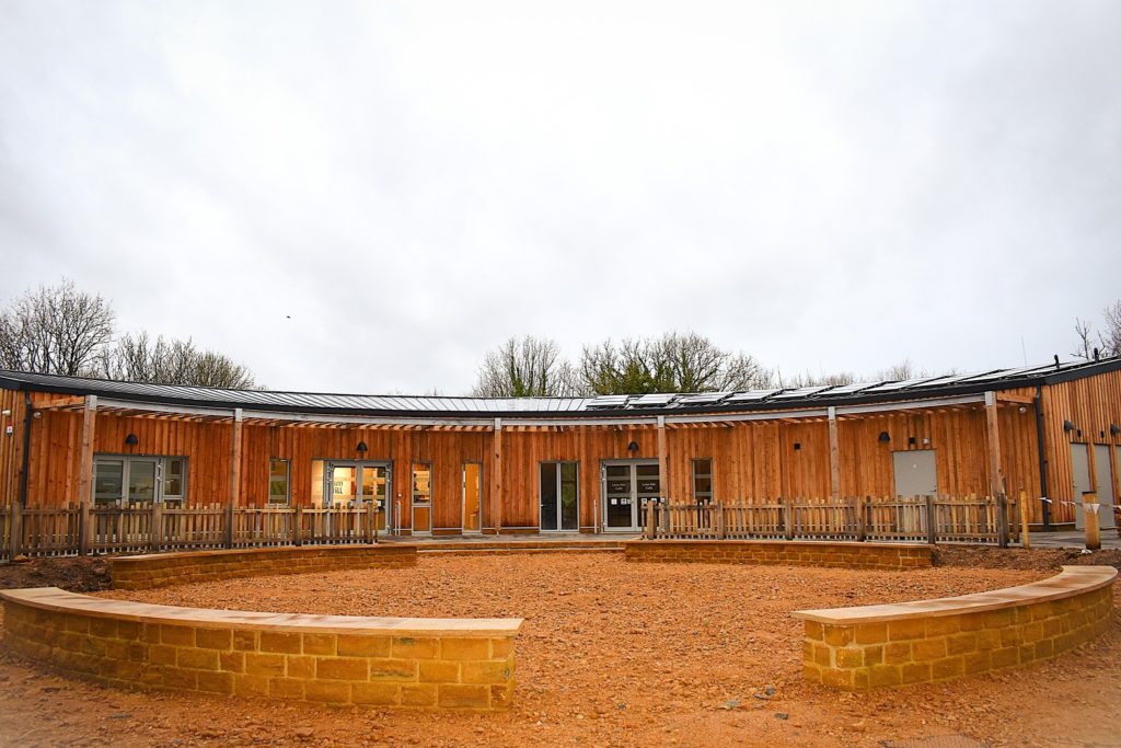Ham Hill visitor centre building with timber cladding and curved design, developed as part of the National Lottery Heritage Fund project.