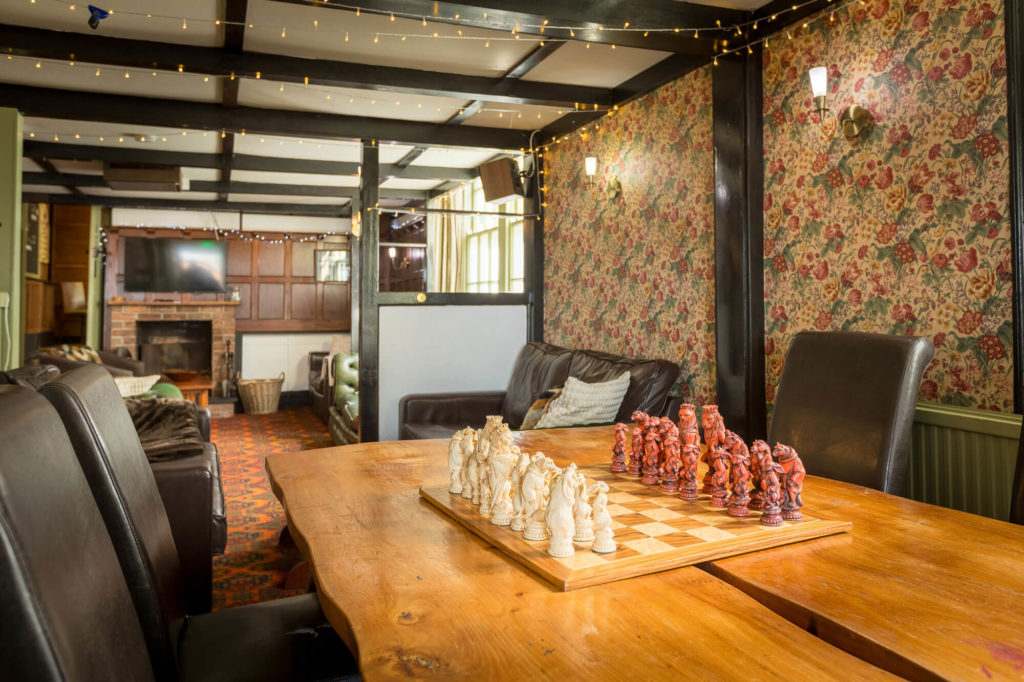 A restaurant table with a chess set on it