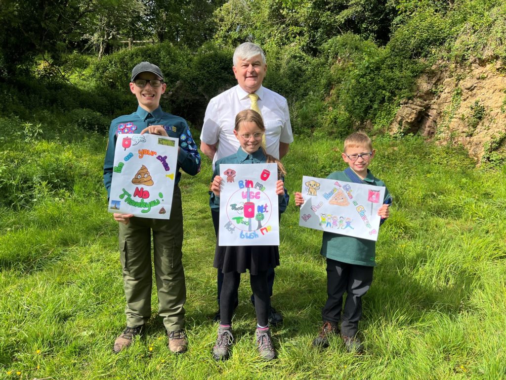 Young Scouts display handmade posters promoting responsible dog ownership and tackling dog fouling at Ham Hill with Cllr Graham Oakes.